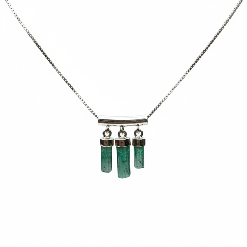 Necklace with green cylindrical pendants on a white background
merald necklace with Colombian emerald